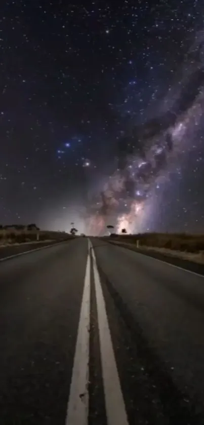 Dark road under a vibrant starry sky with galaxy view.