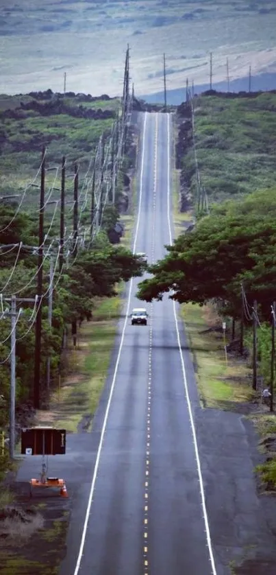 Scenic road with lush green surroundings and open sky in the background.