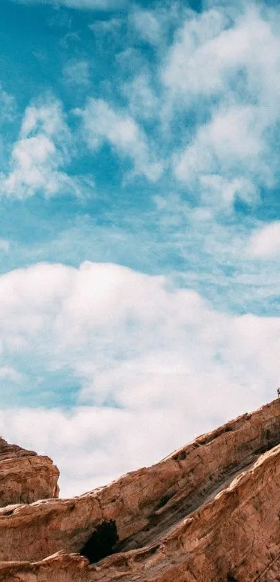 Blue sky with rocky cliff landscape wallpaper.