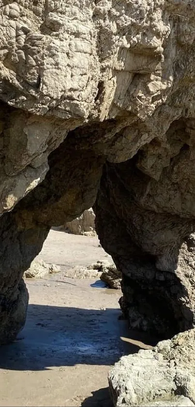 Rock arch on a sunny beach, perfect for wallpaper.