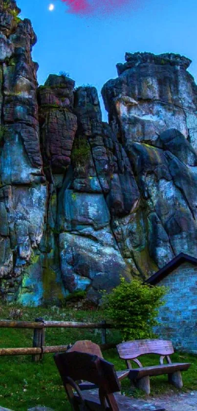 Majestic rock formations under twilight blue sky, featuring lush greenery.