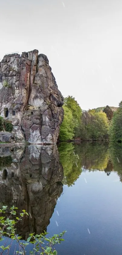 Mobile wallpaper of rocks reflecting on a tranquil lake.