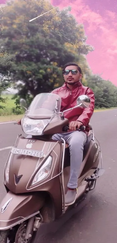 Man riding a scooter with pink skies and greenery.