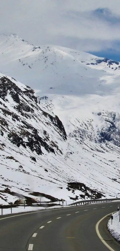 Snowy mountain road with serene winter landscape.