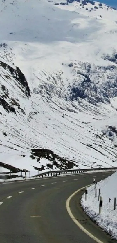 Snowy mountain road with serene winter scenery.