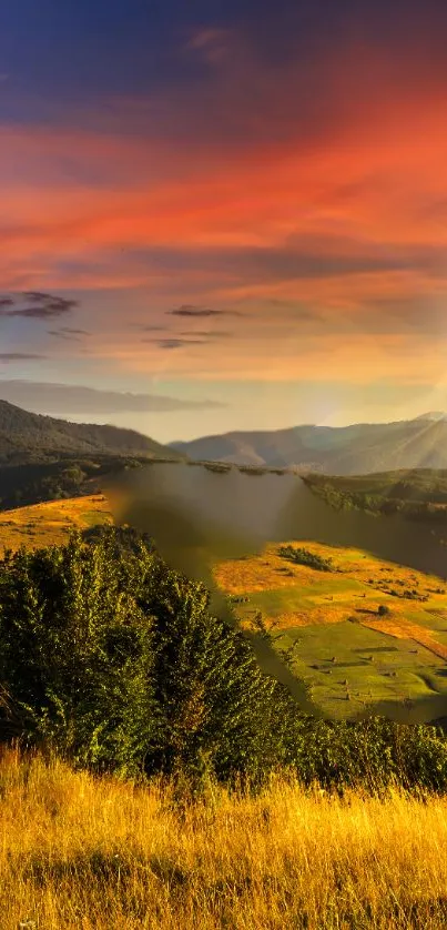 Scenic sunset landscape with green valley under glowing orange sky.