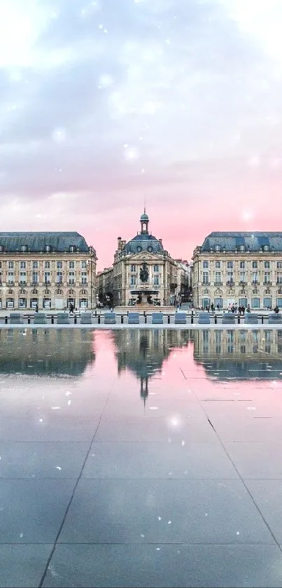 Grand palace reflecting in water at sunset with pink skies.