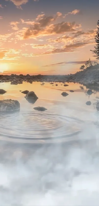 Sunset reflecting over a tranquil lake with rocks and trees silhouetted.