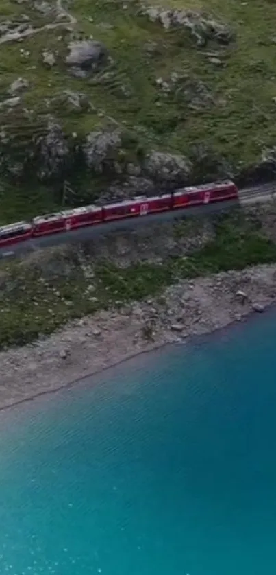 A red train travels alongside a turquoise lake in a rocky landscape.