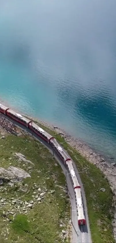 A train travels along a tranquil aquamarine lake beside lush greenery.