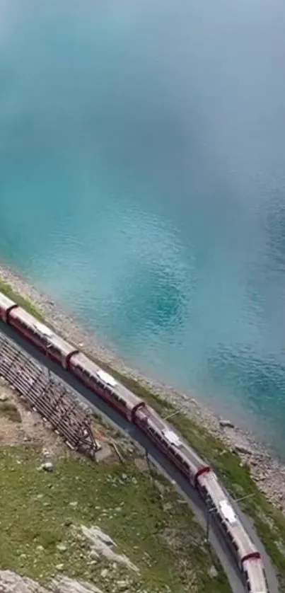 Aerial view of a train by a stunning blue lake, perfect for mobile wallpaper.