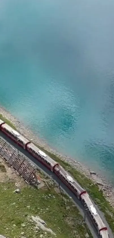 Train travels by a serene, turquoise lake.