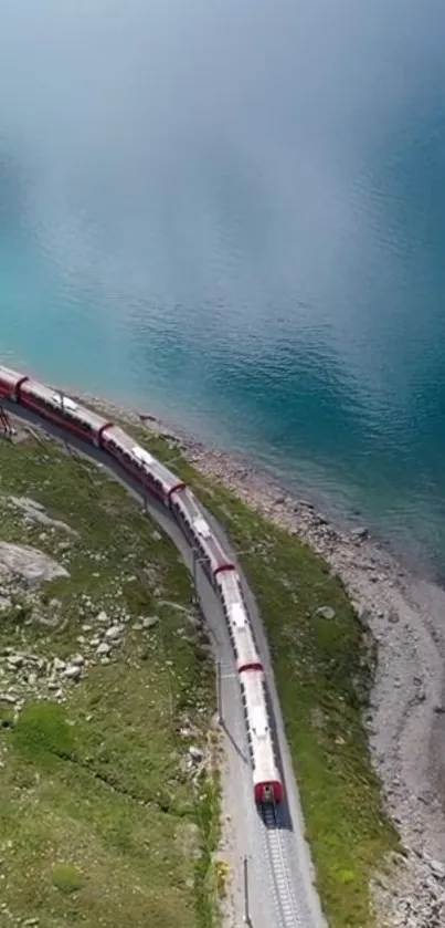 Aerial view of a train by a serene blue lake in a scenic landscape.