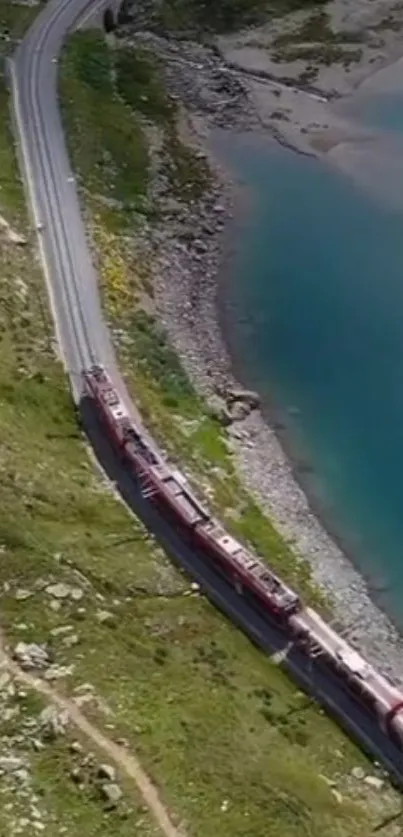 A scenic train travels by a turquoise lake over lush greenery.