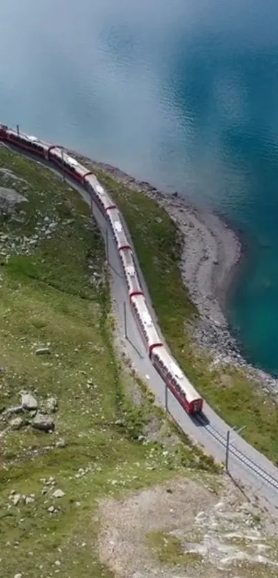 Red train beside turquoise lake in scenic mountain landscape.