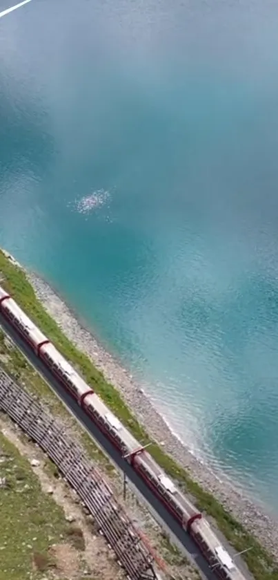 A scenic train journey along a turquoise lake.