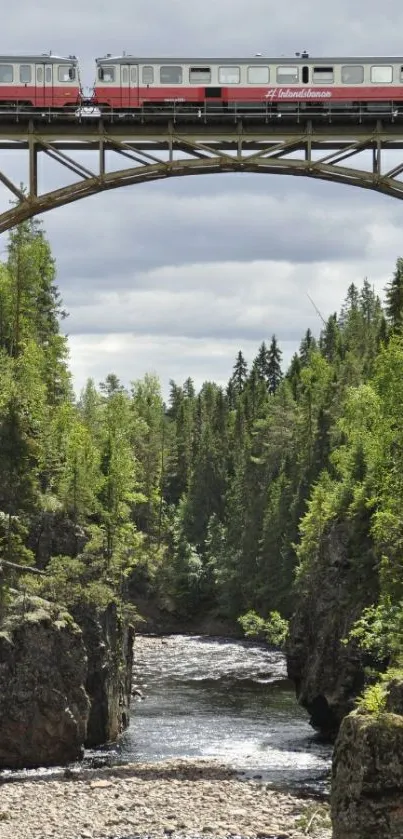 Train crossing a forest bridge over a river gorge.