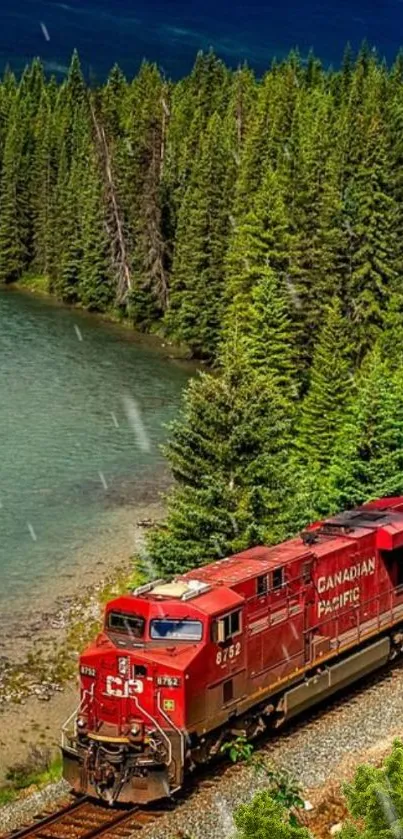 Red train traveling through lush green forest alongside a calm, scenic lake.