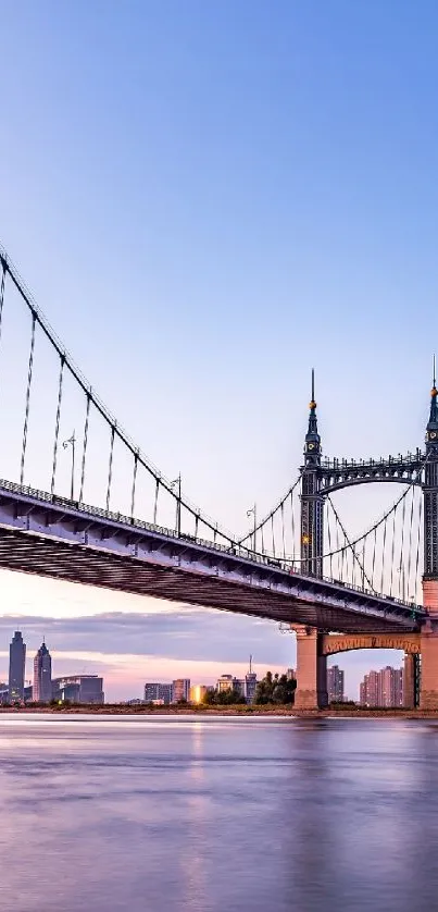 Scenic urban suspension bridge at twilight with city skyline.