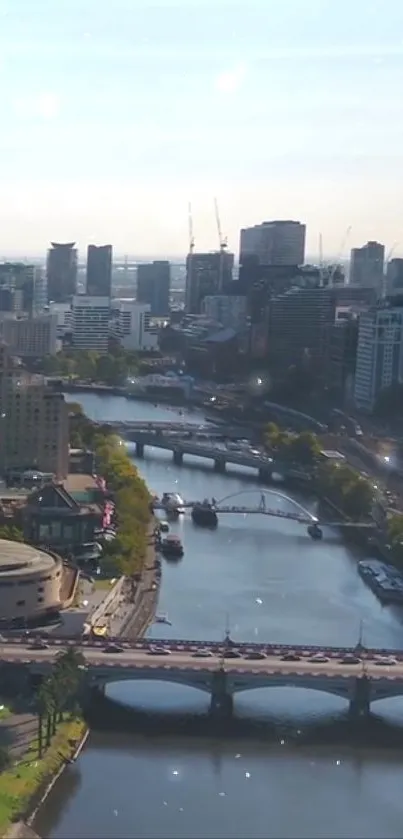 Scenic cityscape with a river and bridge under a clear blue sky.