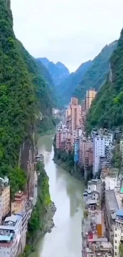 Scenic urban valley with river and mountains.