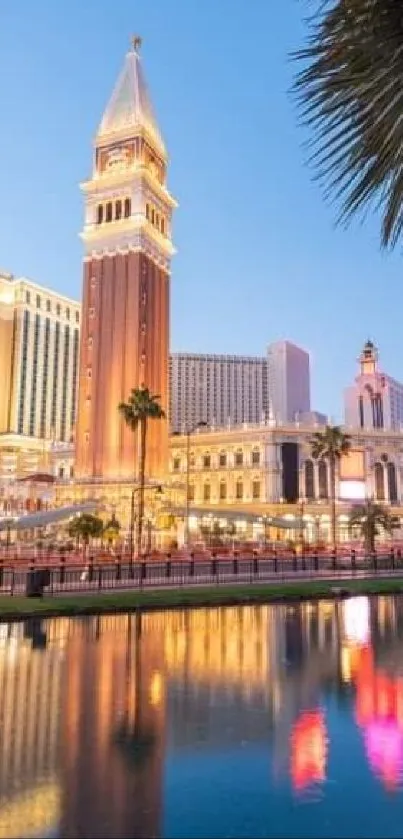 Las Vegas skyline with palm trees and reflections in the water at sunset.