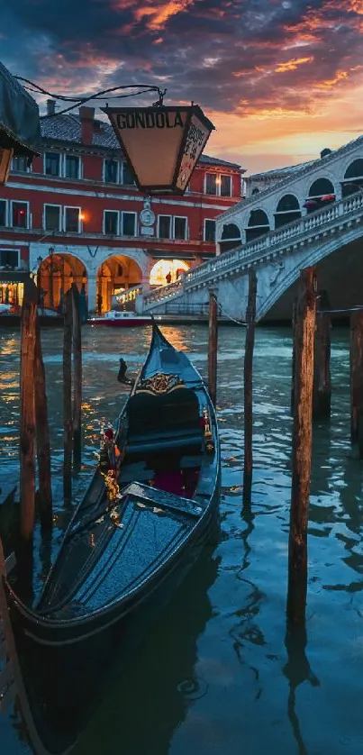 Gondola on Venice canal with Rialto Bridge at sunset.