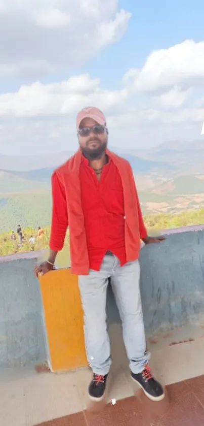 Person in red shirt with scenic mountain background