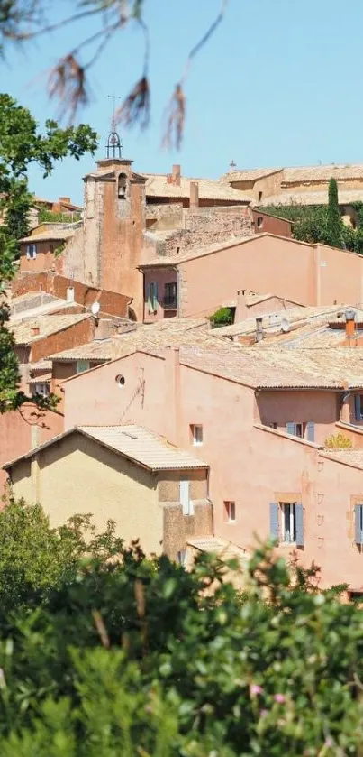 Scenic terracotta rooftop village under clear blue sky.