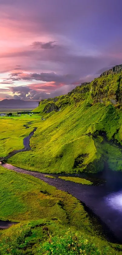 Stunning waterfall flows over vibrant green cliffs at sunset, creating a serene landscape.