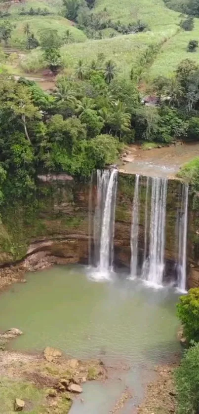 Aerial view of a waterfall in a lush green forest.