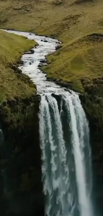 Peaceful landscape with waterfall in lush green hills.