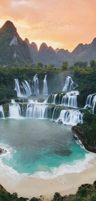 Beautiful waterfall and mountains at sunset with vibrant teal and orange hues.