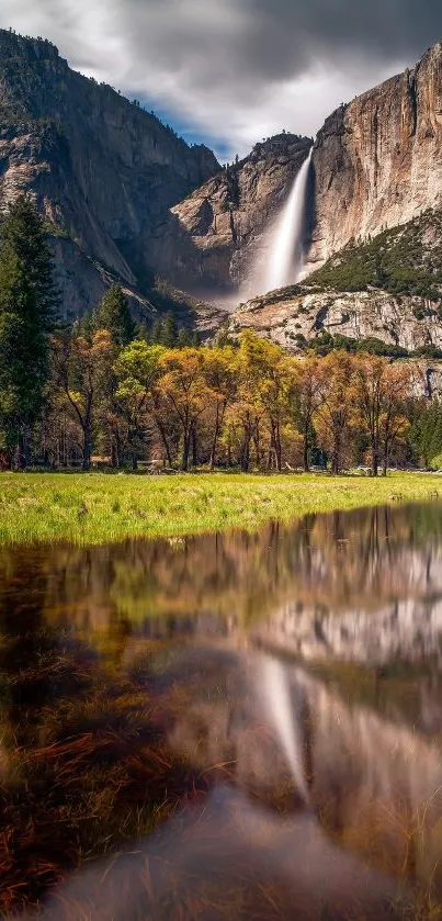 Majestic waterfall against rocky mountains with reflecting water below.
