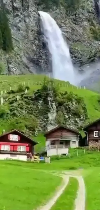 Charming village below stunning waterfall with lush green landscape.