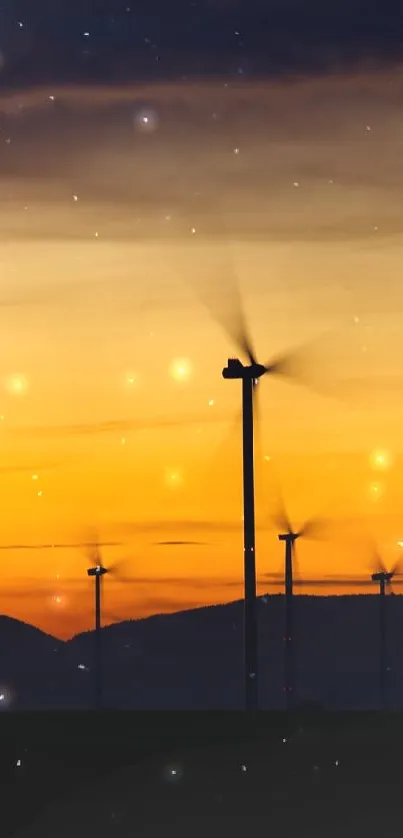 Wind turbines silhouette against an orange sunset sky.