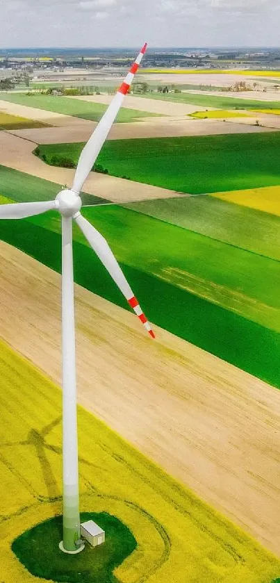 Aerial view of a wind turbine over colorful fields.