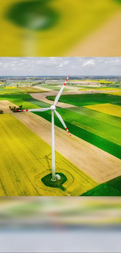 Aerial view of a wind turbine standing in lush green fields.