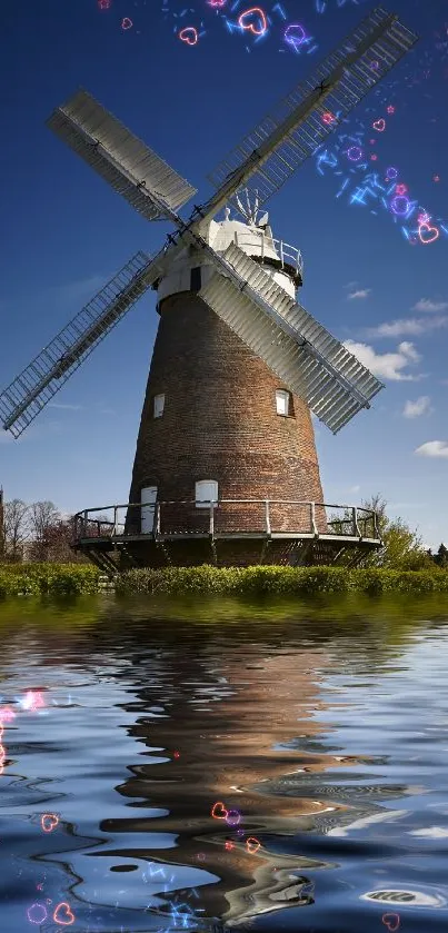 Windmill against a clear sky, reflecting in water.