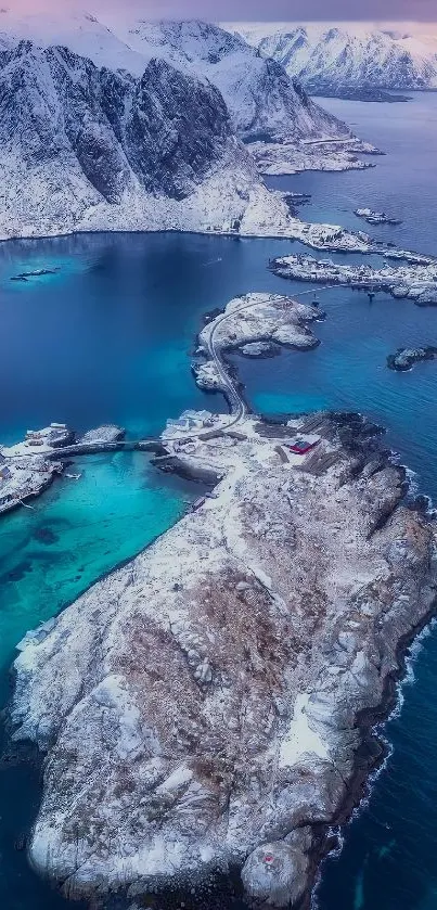 Snow-covered coastal landscape with blue waters and mountains.