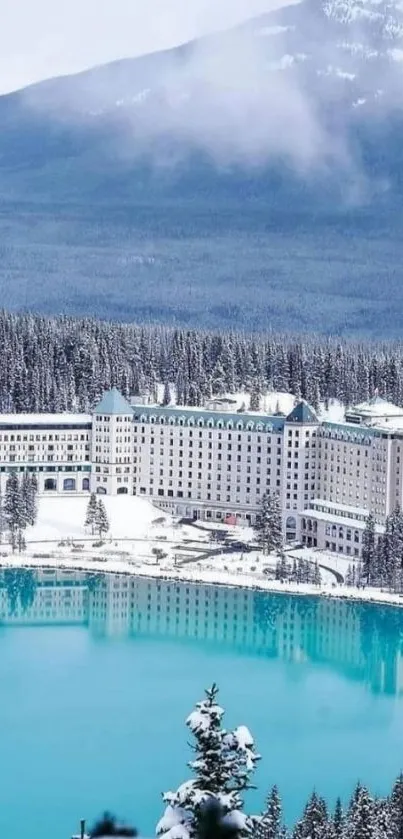 Scenic winter landscape with hotel by turquoise lake and snow-capped mountains.