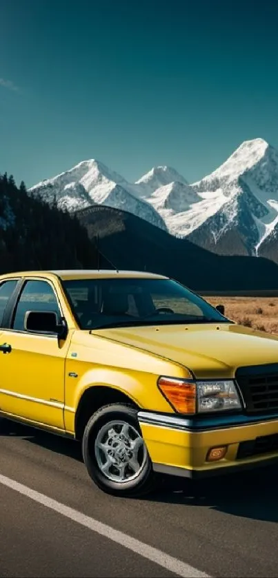 Yellow car on scenic road with mountains behind.