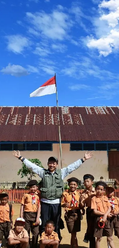 Children in school uniforms under blue sky in front of a rustic building.