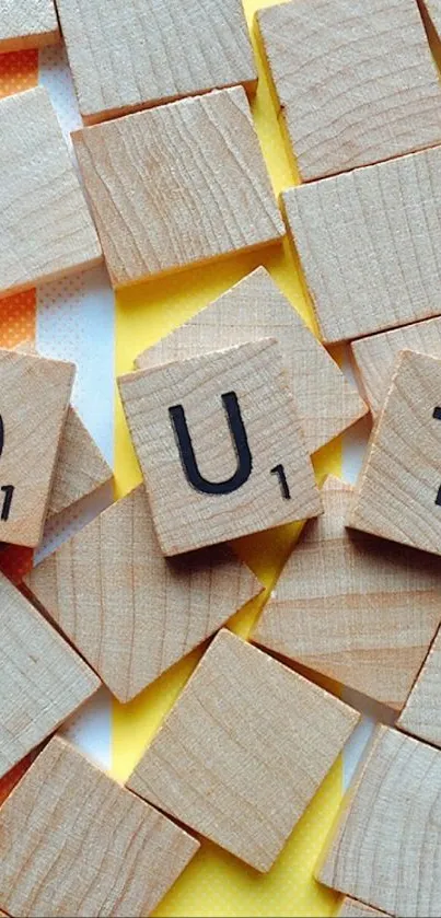 Mobile wallpaper with Scrabble tiles spelling 'OUT' on colorful background.