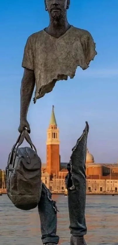 Modern sculpture with sunset sky and water in background.