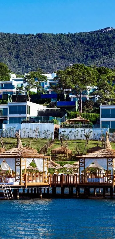 Seaside cabins with forested backdrop and blue waters.