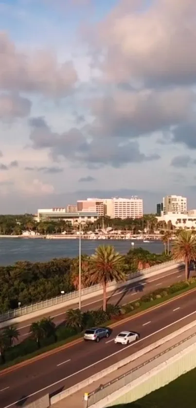 Seaside cityscape featuring a road along the ocean with a vibrant sky above.