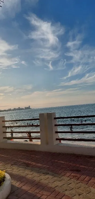 Seaside view with sunset and ocean under a blue sky.