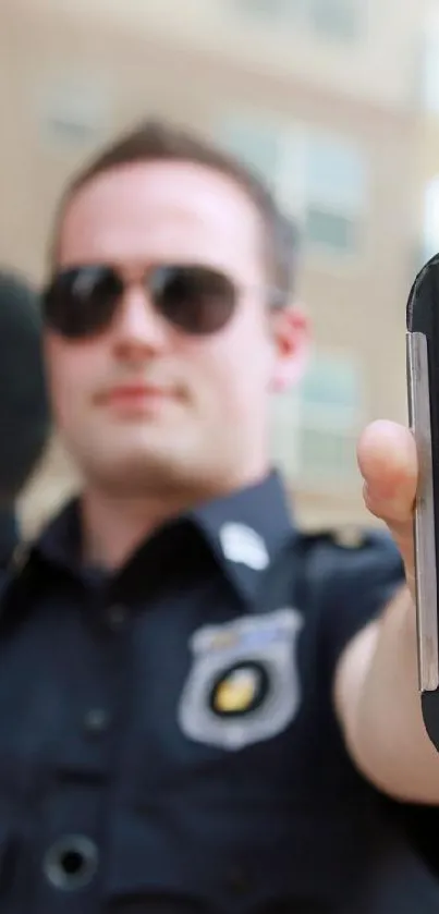 Security officer displaying smartphone app.