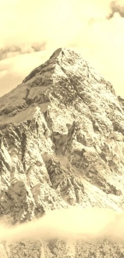 Sepia-toned majestic mountain summit with clouds.